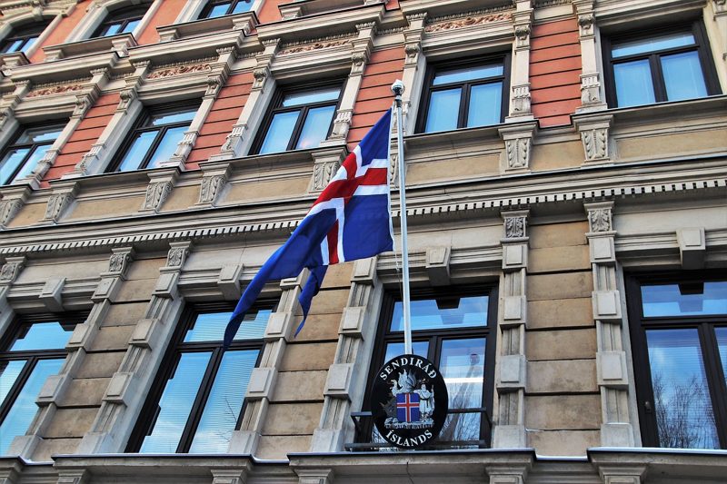 Illustration: The flag of Iceland on a building with a sign
