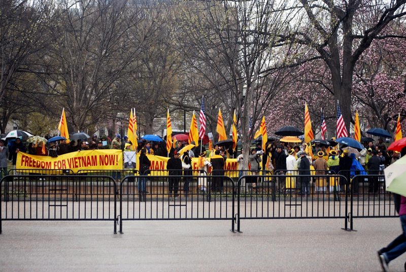 Illustration: People protesting with yellow flags and a banner reading freedom
