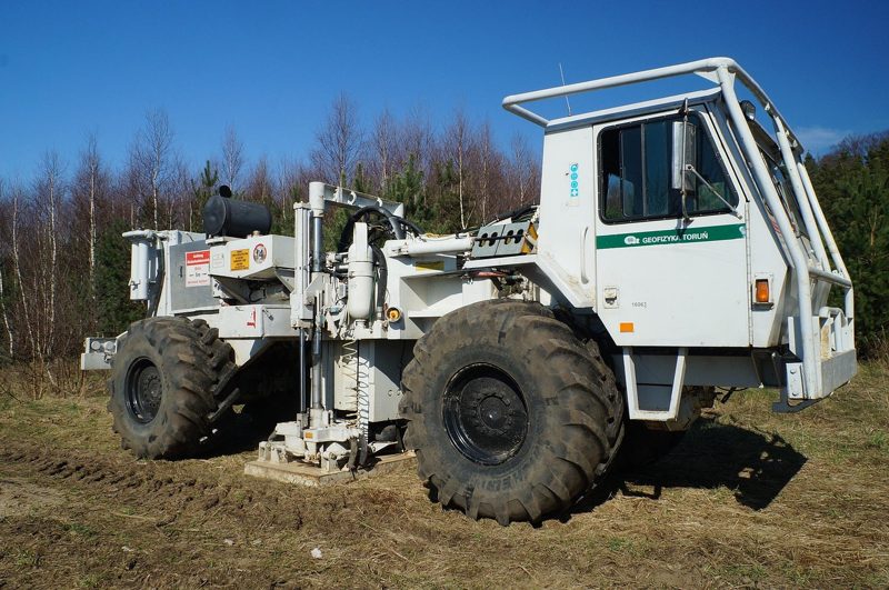 Illustration: A white service vehicle in the woods on a sunny day