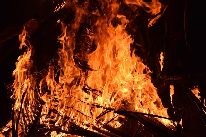 Illustration: Flames of a large fire against a dark background