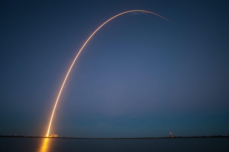 Illustration: A rocket launching into the sky at night