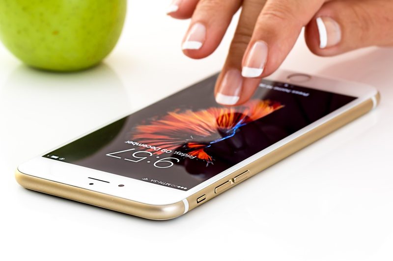 Illustration: A person touching the screen of a smartphone