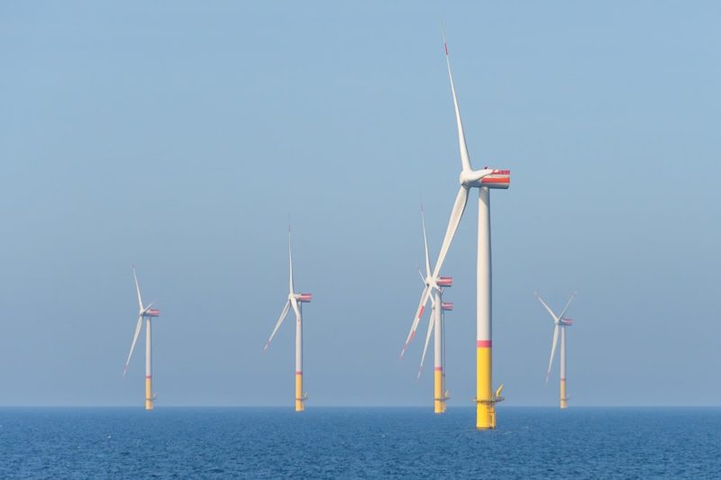 Illustration: Wind turbines in the sea under a clear blue sky