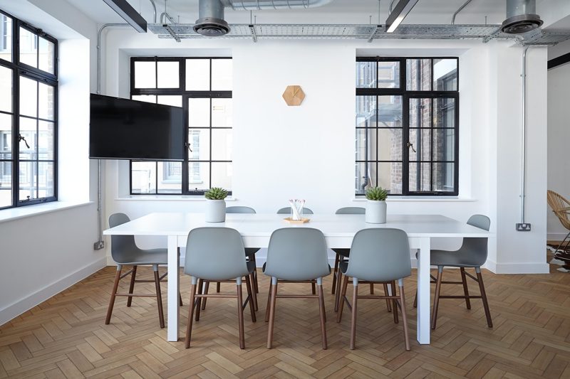 Illustration: A bright modern meeting room with a large white table