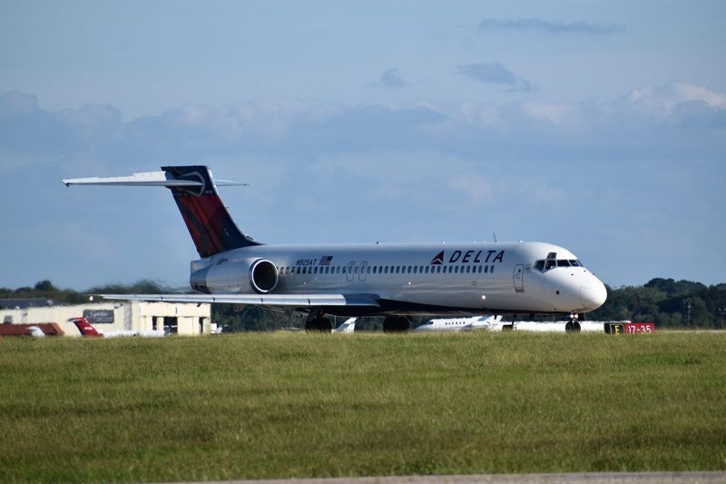Illustration: A Delta airliner on the grass near a runway