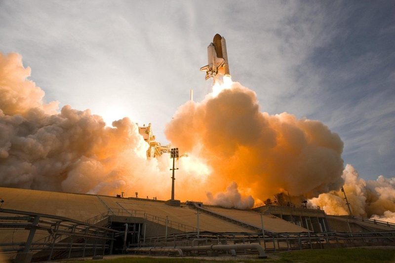 Illustration: A space shuttle launching into the sky with massive smoke plumes