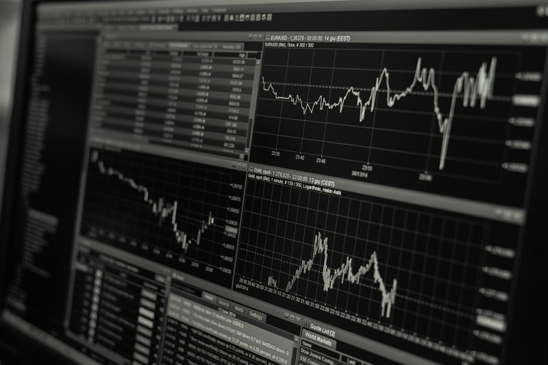 Illustration: Computer monitor displaying financial charts and market data graphs