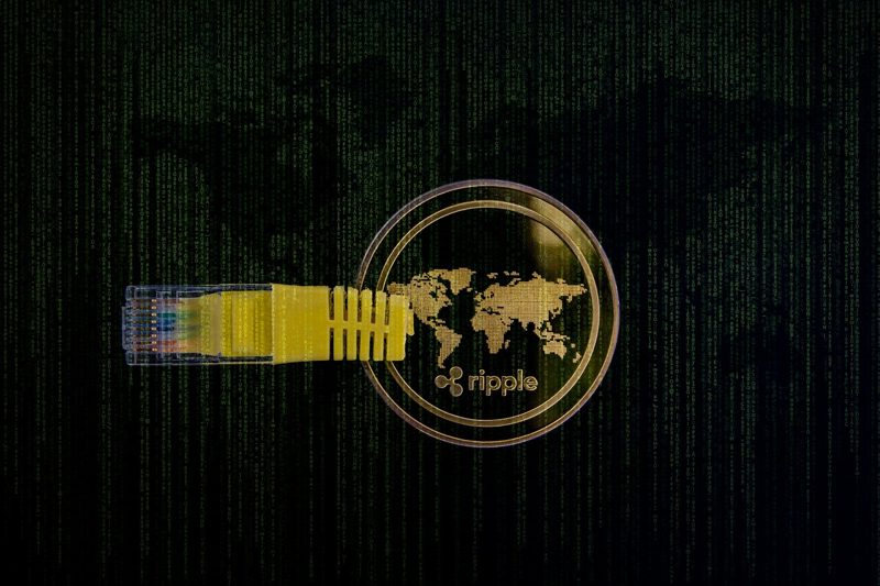 Illustration: A ripple crypto coin with an ethernet cable on a dark background