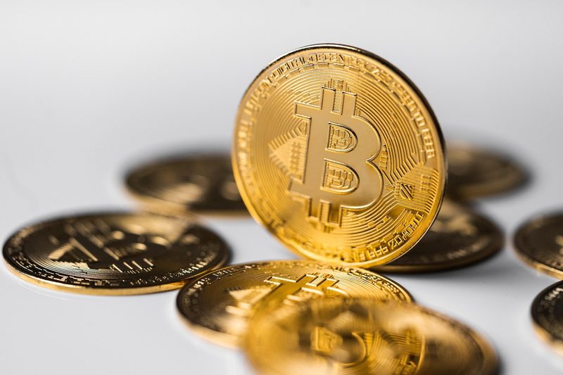 Illustration: Several bitcoin coins placed on a white surface