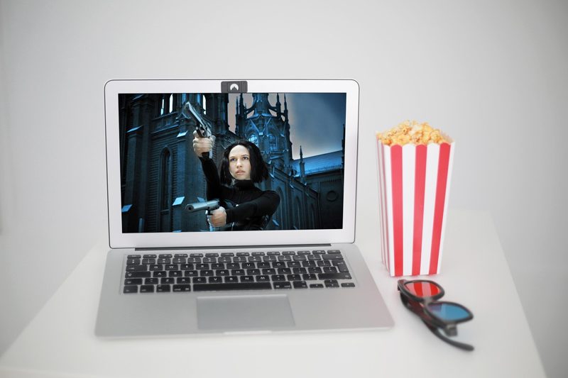 Illustration: A laptop showing a movie with popcorn and 3D glasses