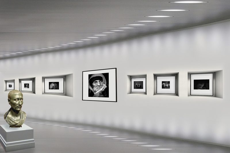 Illustration: An art gallery with black and white pictures and a sculpture