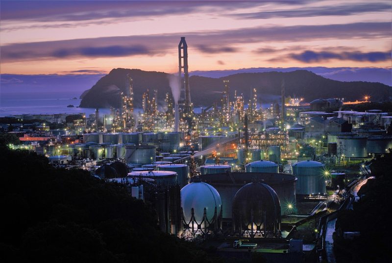 Illustration: An illuminated industrial plant during twilight