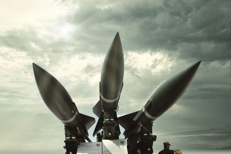 Illustration: Military missiles pointed towards the sky against a cloudy background