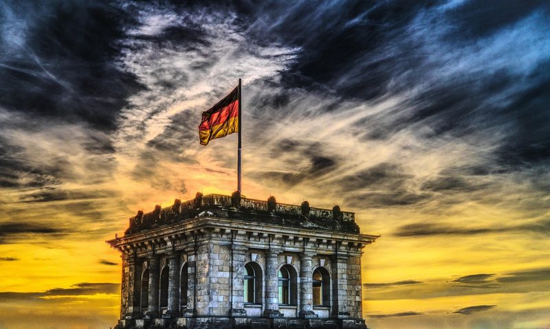 Illustration: The Reichstag building in Berlin with a German flag