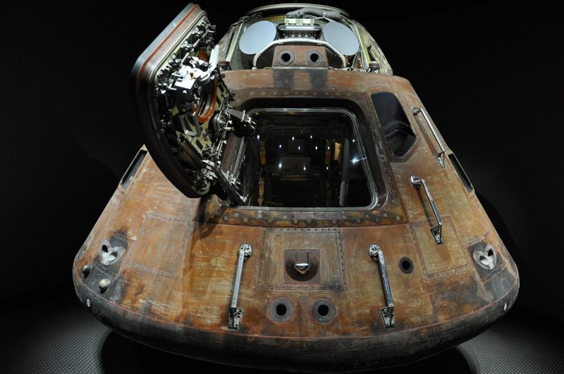 Illustration: A well-worn space capsule with its hatch open