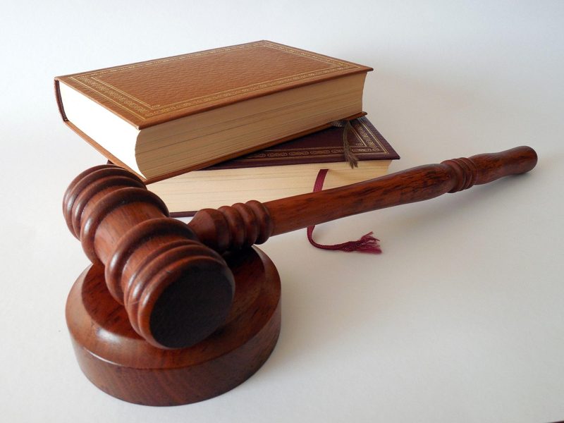 Illustration: A wooden gavel and sound block next to law books
