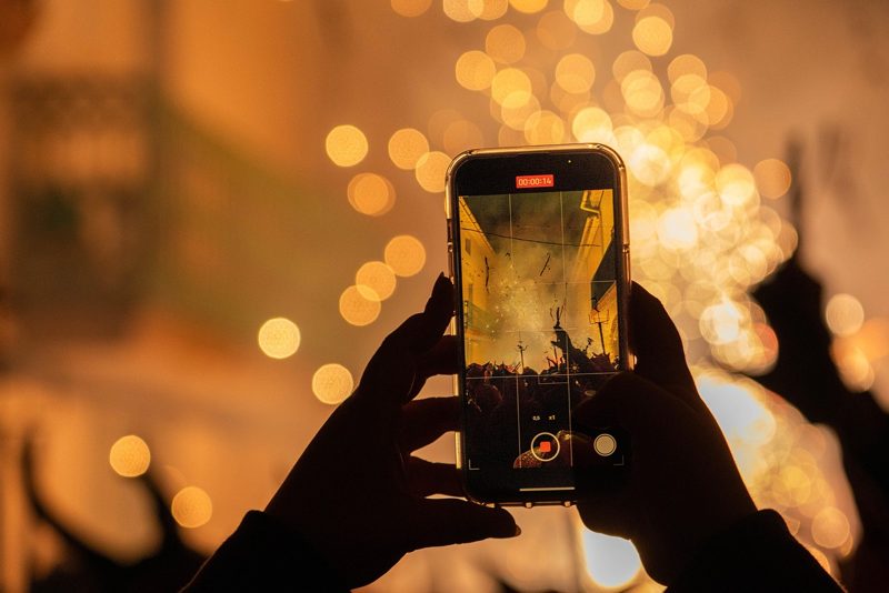 Illustration: A person recording a video with a smartphone outdoors