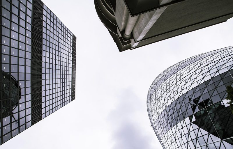 Illustration: Modern skyscrapers seen from below against the sky