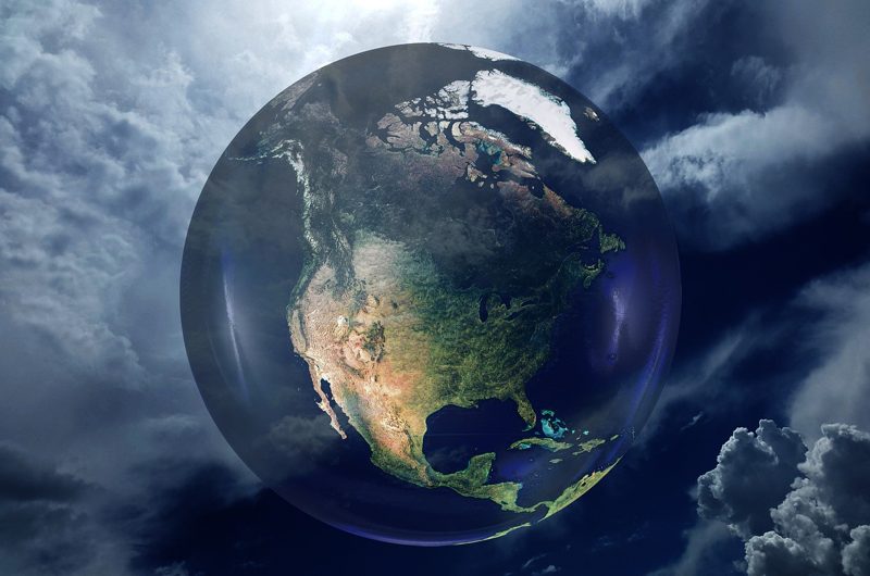 Illustration: Earth floating in space against a cloudy background