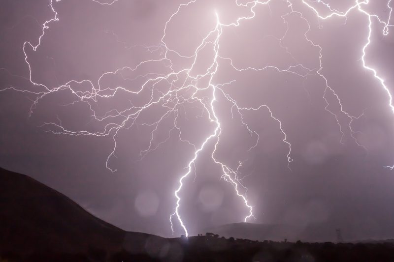 Illustration: Lightning striking the ground during a stormy night