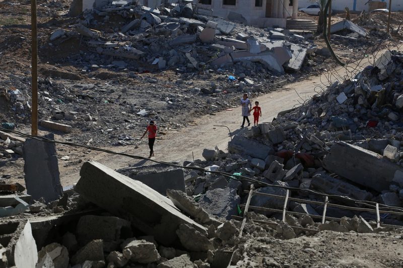 Illustration: People walking through a ruined area surrounded by concrete rubble