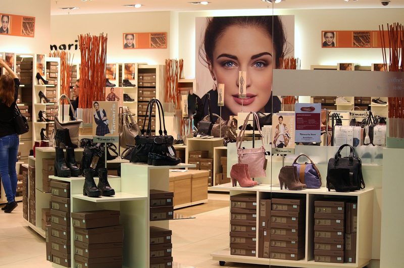 Illustration: A shoe and handbag store with display shelves and posters