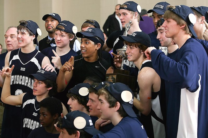 Illustration: A group of young men in sports uniforms holding a trophy