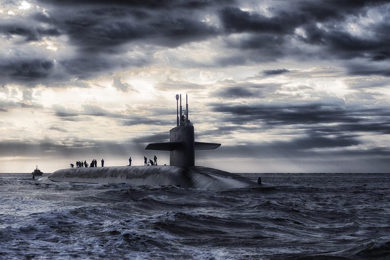 Illustration: A submarine sailing on the sea under a dark sky