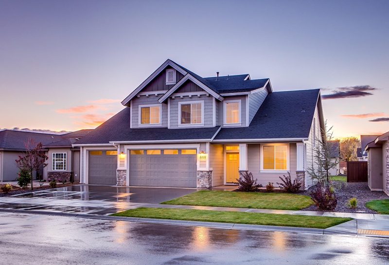 Illustration: A suburban house with a paved driveway in the evening