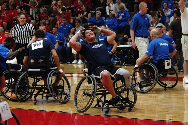 Illustration: People in wheelchairs playing basketball in a gymnasium