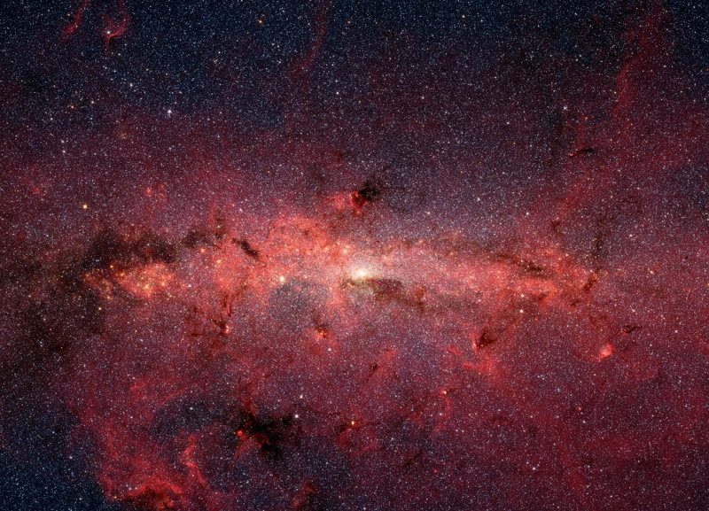 Illustration: A galaxy with many stars and glowing dust clouds