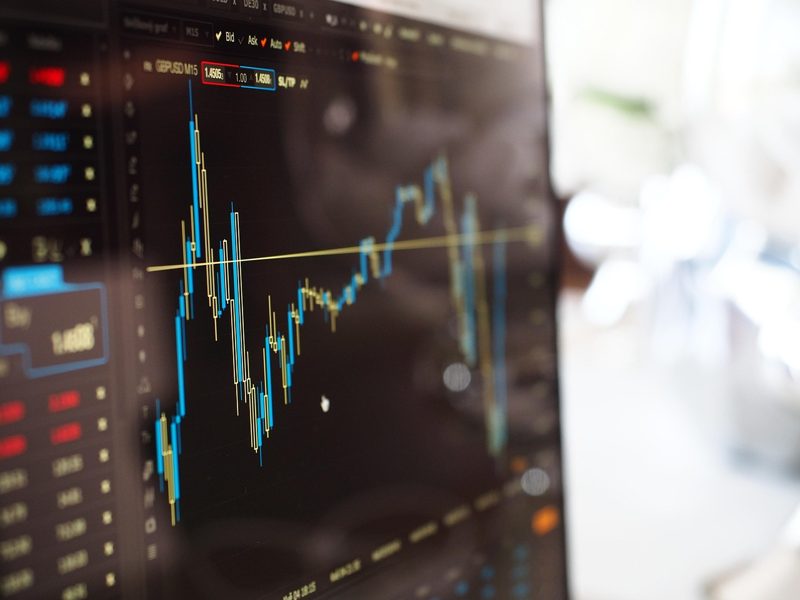 Illustration: A monitor displaying a stock market graph in blue and yellow