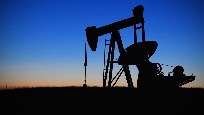 Illustration: A silhouette of a oil pump jack against a twilight sky