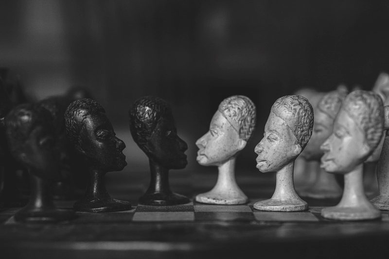 Illustration: Chess pieces with human faces facing each other