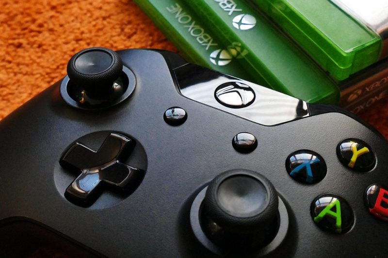 Illustration: An Xbox controller with a green game case