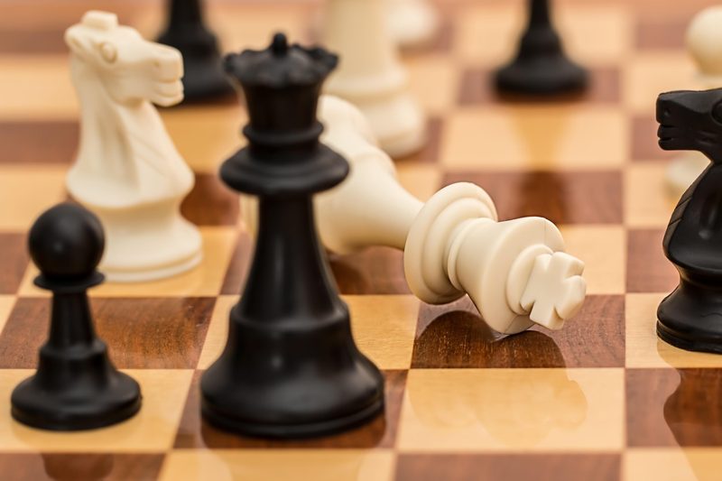 Illustration: A chess board with a fallen white king piece