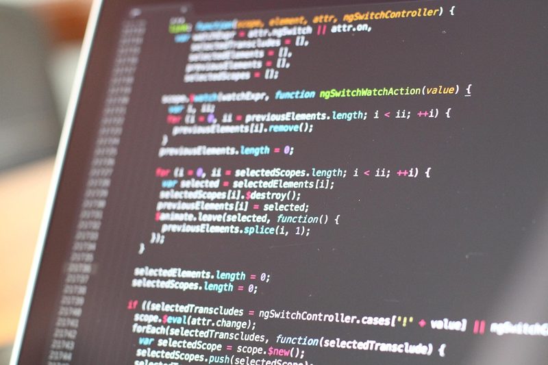 Illustration: A laptop screen showing computer code