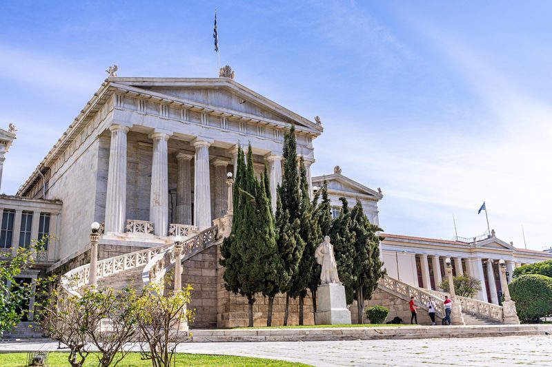 Illustration: The neoclassical academy building in Athens under a blue sky