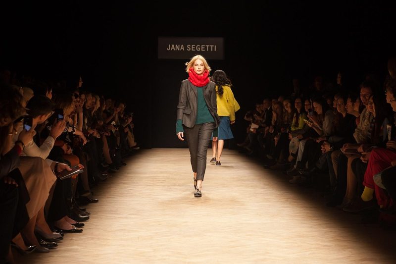 Illustration: A model walking on a runway at a Jana Segetti fashion show