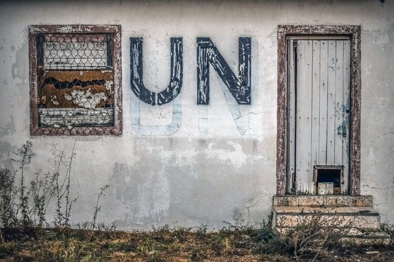 Illustration: The letters "UN" on a weathered wall