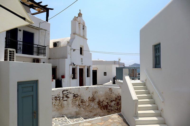 Illustration: White buildings and a church in Greece