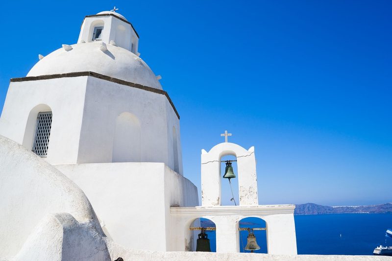 Illustration: White church with bells under blue sky