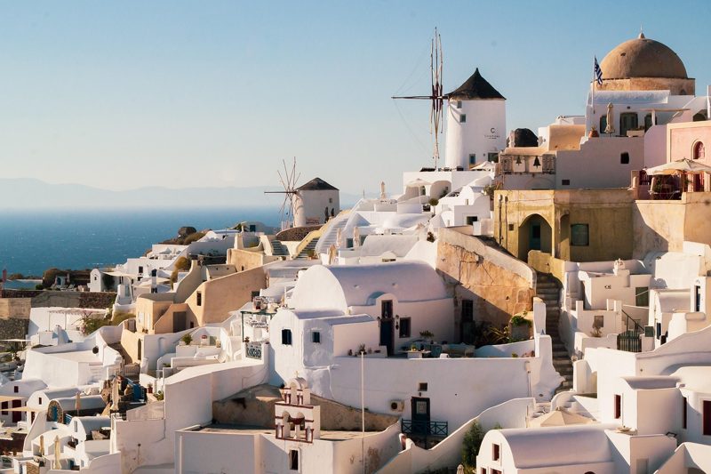 Illustration: White houses and windmills on a hillside