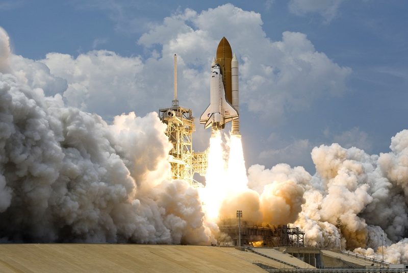 Illustration: A space shuttle launching with huge clouds of smoke
