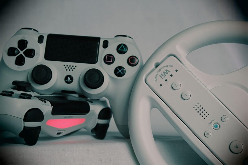 Illustration: A collection of game controllers and a steering wheel