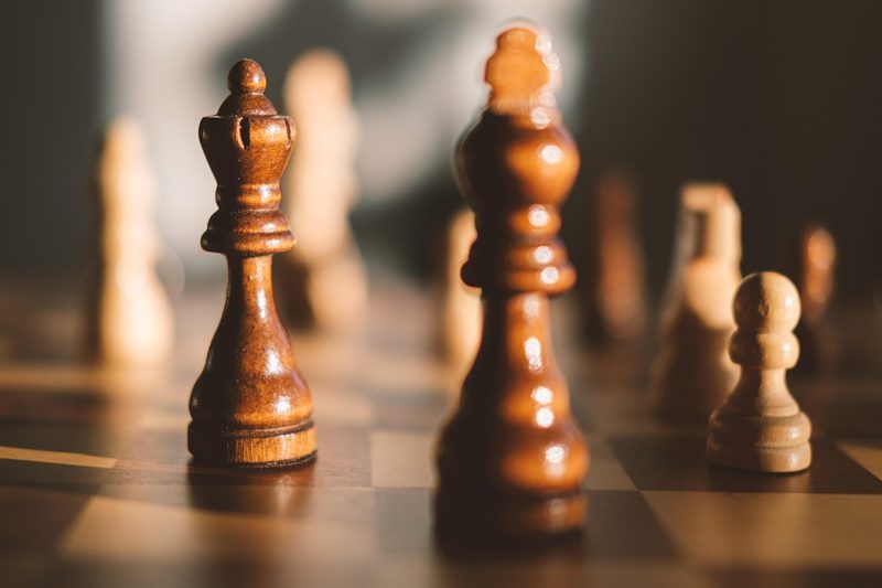 Illustration: A close up view of chess pieces on a board