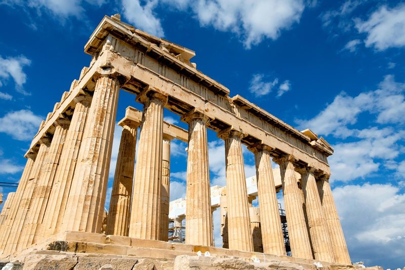 Illustration: The Parthenon in Athens against a blue sky with clouds
