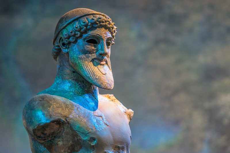 Illustration: An ancient bronze bust in a museum
