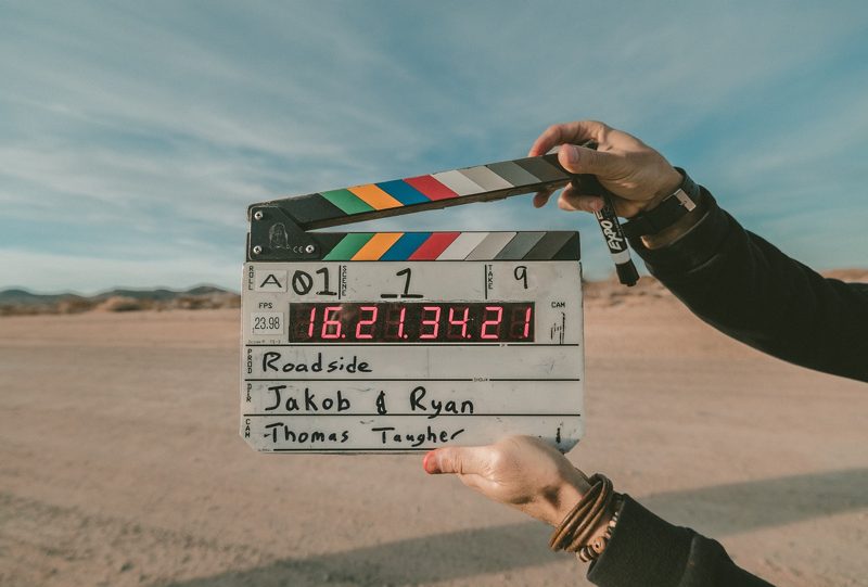 Illustration: A film clapperboard being held outdoors
