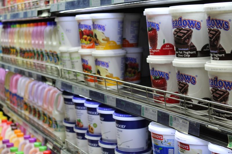 Illustration: A supermarket shelf filled with multiple varieties of yogurt tubs